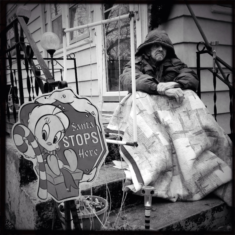 Hospice patient Fred Anders, of East Moline, huddles under a blanket while supervising UnityPoint Hospice nurses and staff set-up Christmas decorations in front of his home Tuesday, Dec. 2, 2014.