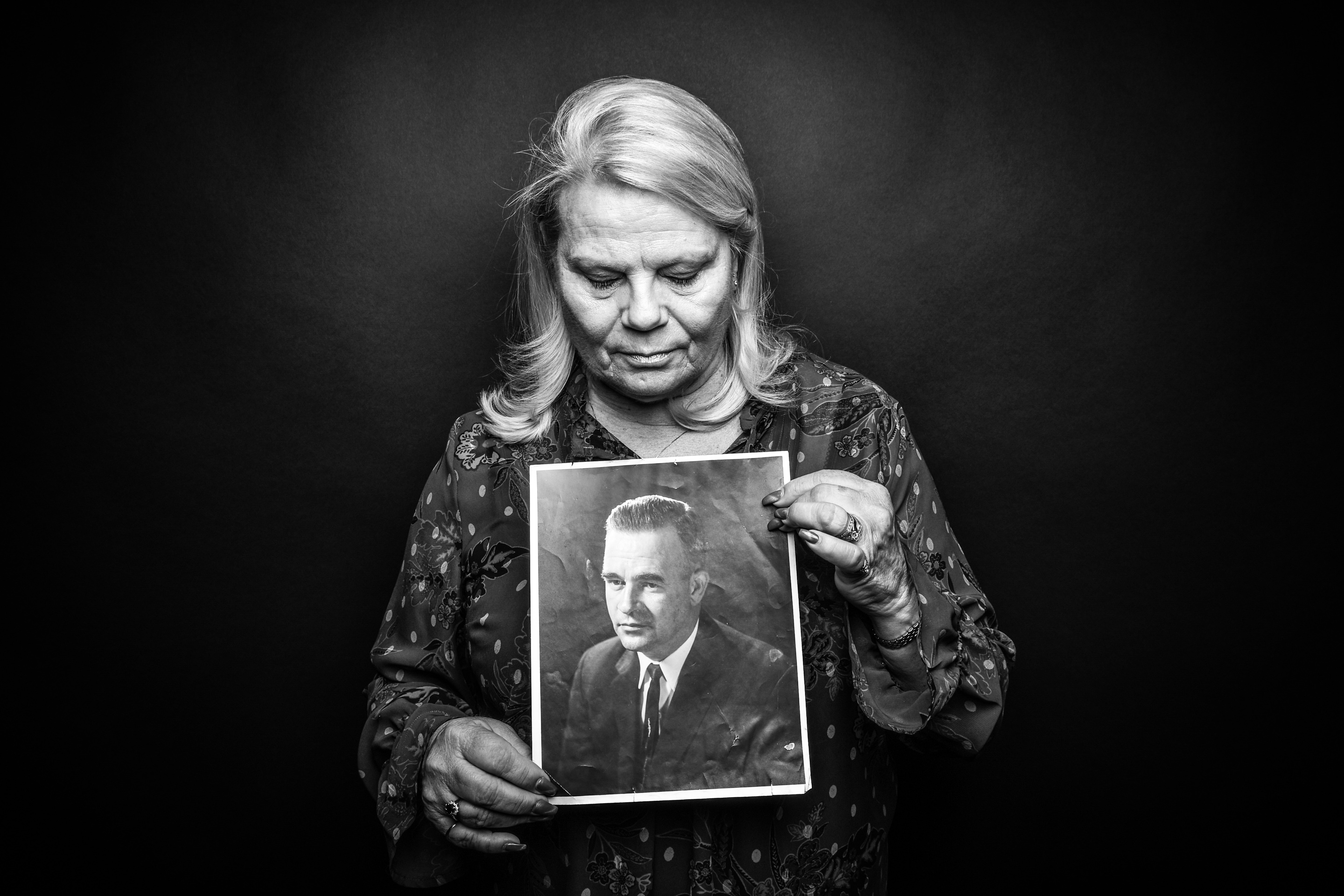 Gaelene Rosinski, Moline, holds a photo of her father, Keith Lane, who died by suicide at 52, in 1975.