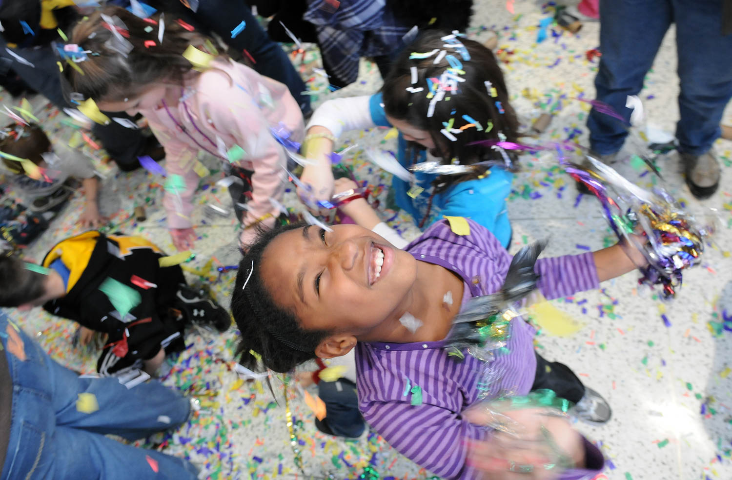 Shyia Sabel, 9 of Davenport, rings in 2013 at Noon Year's Eve the Family Museum, Bettendorf, on Jan. 31, 2012. The event which gives families to celebrate New Year's Eve a little early featured music by The Myers Brothers, crafts, party hats, noisemakers, a countdown to noon, and confetti. (Todd Mizener - Dispatch/Argus)