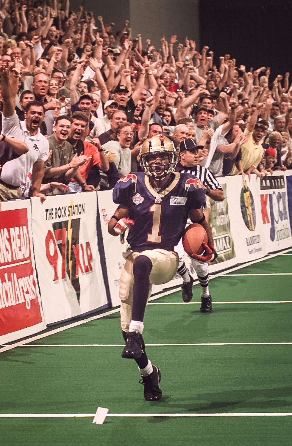 The capacity crowd in The Mark of the Quad Cities goes crazy as Quad City Steamwheelers' Shon King returns the opening kick-off for a touchdown in the 2000 ArenaCup championship. The 'Wheelers went on to win the championship game over the Tennessee Valley Vipers (68-59) to complete their undefeated season (16-0). (Todd Mizener - Dispatch/Argus)