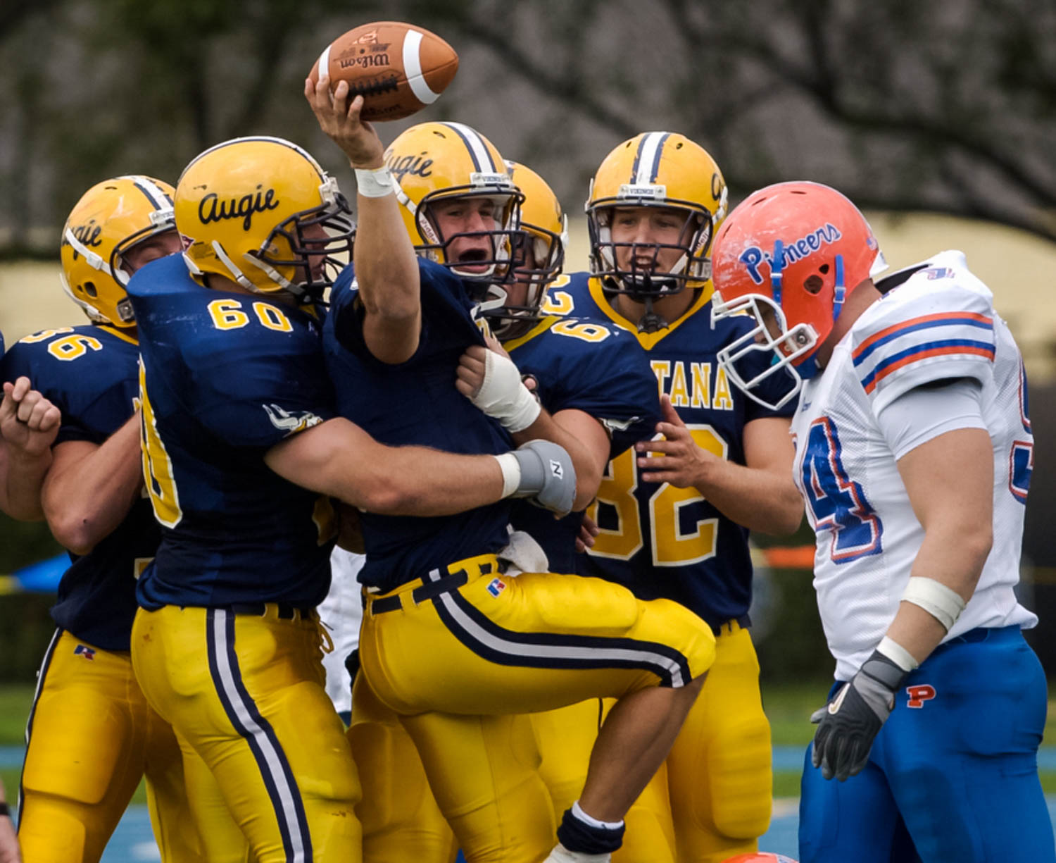 Augustana quarterback Brad Wendell celebrates his second- quarter touchdown with his teammates Saturday afternoon as a dejected Shawn Busch of Wisconsin-Platteville walks past the Vikings. Wendell scored on a 9-yard run. (Todd Mizener - Dispatch/Argus)