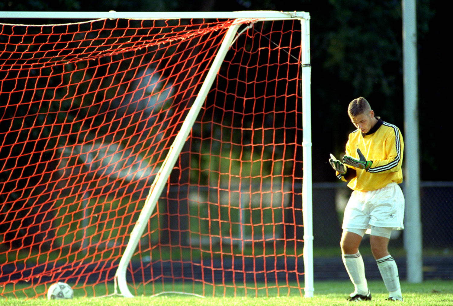 Moline High School soccer goalie Dan Schmidt stares at his hands in disbelief after allowing the eventual game winning goal to arch rival Rock Island. Moline previously had never lost to Rock Island in the history of the two programs. (Todd Mizener - Dispatch/Argus)