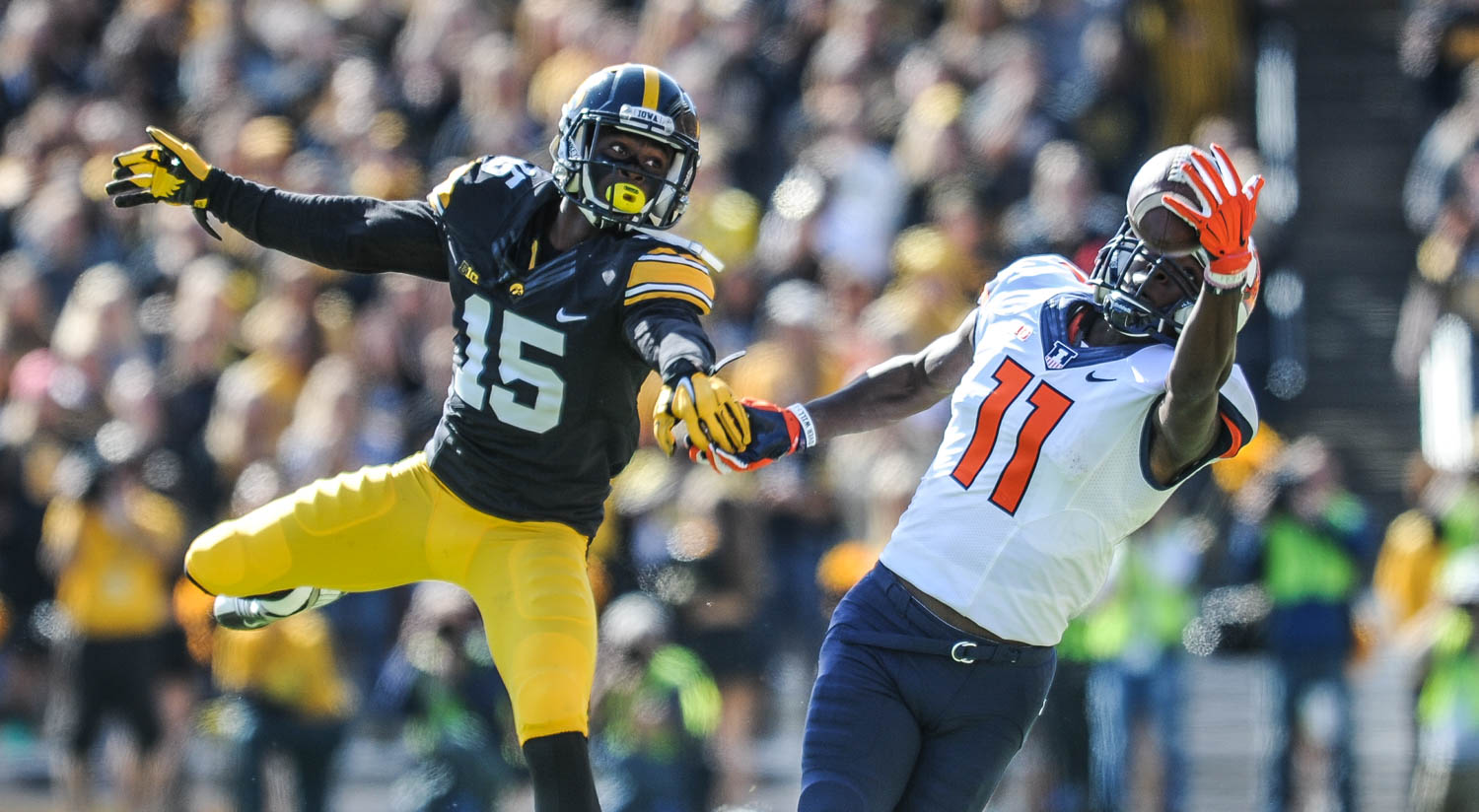 Illinois wide receiver Malik Turner eyes a catch ahead of Iowa defender Joshua Jackson during the first half of their game Saturday, October 10, 2015, at Kinnick Stadium in Iowa City. Iowa defeated the Illlini, 29-20.  (Todd Mizener - Dispatch/Argus)