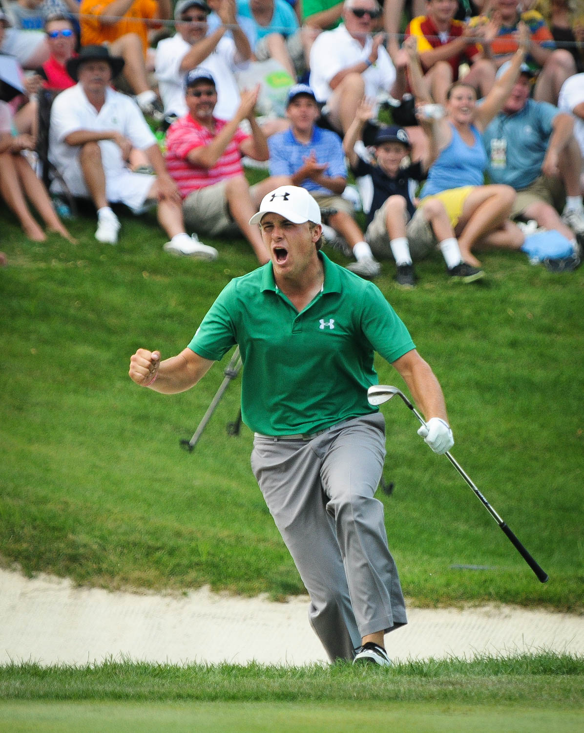 PGA Tour pro Jordan Spieth reacts to chipping in from the bunker for a birdie on the 18th hole during the final round of the John Deere Classic golf tournament in Silvis, Ill., Sunday, July 14, 2013. Spieth won the tournament on the 5th playoff hole. (Todd Mizener - Dispatch/Argus)