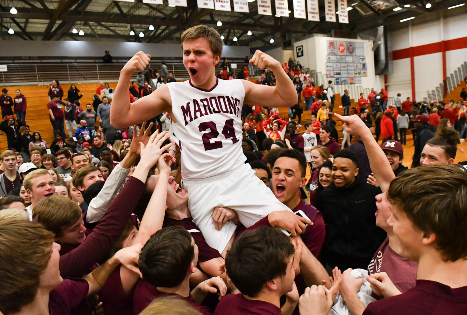 Moline fans lift Ethan Lapaczonek (24) on their shoulders after the Maroons defeated Rock Island, 55-43, in the Class 4A Pekin Sectional Tuesday, March 6, 2018, at Dawdy Hawkins Gym. (Todd Mizener - Dispatch/Argus)