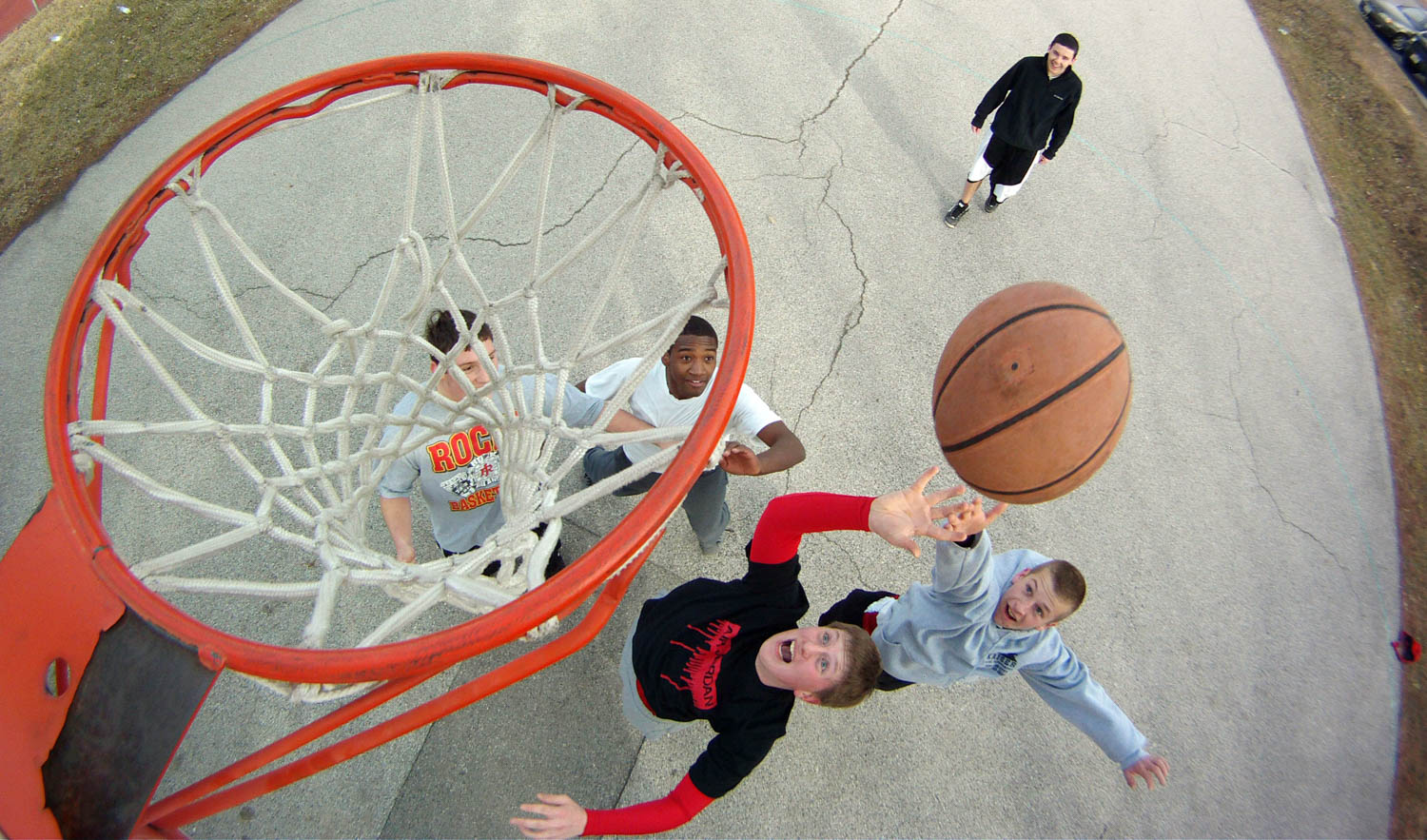 Brett Livingston, Keenen Ruiz, Jordan Groom and Joseph Perez battle for a rebound during a pick-up game of basketball in Rock Island's Lincoln Park Monday February 20, 2012. Standing in the background is David Hansen. The group of friends are all students at Rock Island High School, and were enjoying a day off from school because of the Presidents' Day holiday. (Todd Mizener - Dispatch/Argus)